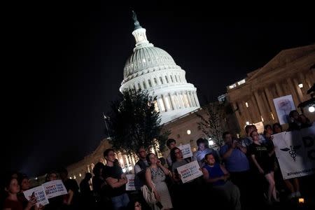 Protesters gather outside the Capitol Building prior to an all night round of health care votes on Capitol Hill in Washington, U.S., July 27, 2017. REUTERS/Aaron P. Bernstein/Files