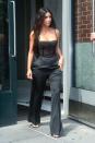 <p>In a black sheer bustier bodysuit, wide-leg trousers, and heeled sandals while out in New York.</p>