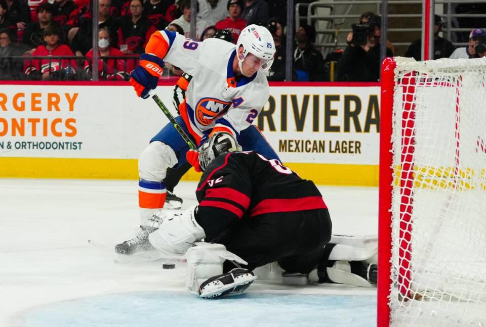 Nov 30, 2023; Raleigh, North Carolina, USA; Carolina Hurricanes goaltender Pyotr Kochetkov (52) stops New York Islanders center Brock Nelson (29) in close during the second period at PNC Arena. Mandatory Credit: James Guillory-USA TODAY Sports