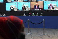 Monitor display showing U.S President Donald Trump, center, together with other leaders attending the first virtual Asia-Pacific Economic Cooperation (APEC) leaders' summit, hosted by Malaysia, in Kuala Lumpur, Malaysia, Friday, Nov. 20, 2020. Leaders from the Asia-Pacific Economic Cooperation forum have begun a virtual meeting to seek ways to revive their coronavirus-battered economies, with U.S. President Donald Trump participating for the first time since 2017. (AP Photo/Vincent Thian)