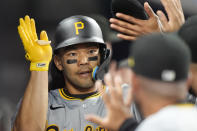 Pittsburgh Pirates' Connor Joe is congratulated by teammates after he scored on a sacrifice fly by Ke'Bryan Hayes during the eighth inning of a baseball game against the Miami Marlins, Friday, March 29, 2024, in Miami. (AP Photo/Wilfredo Lee)