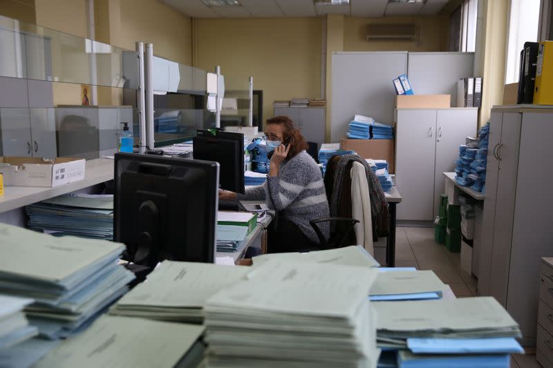 An employee works at a Greek Manpower Employment Organisation (OAED) office near Athens