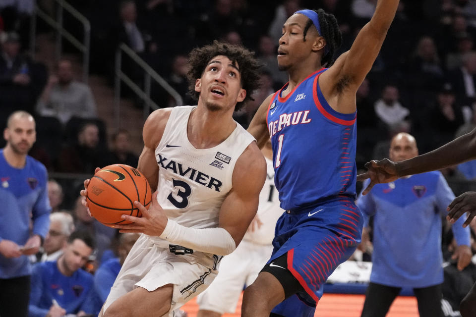 Xavier's Colby Jones (3) drives against DePaul's Javan Johnson (1) in the first half of an NCAA college basketball game during the second round of the Big East conference tournament, Thursday, March 9, 2023, in New York. (AP Photo/John Minchillo)