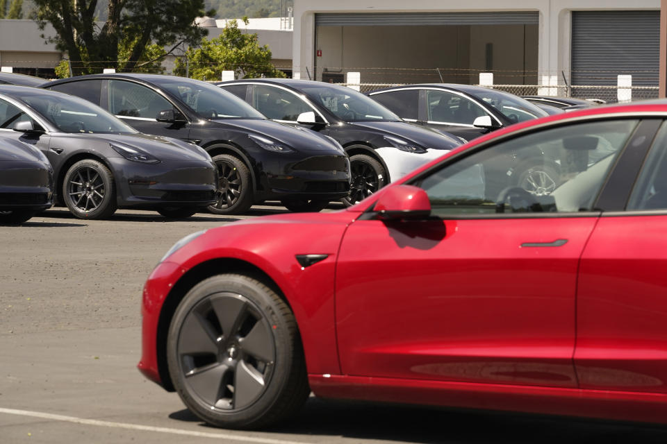 FILE - In this April 2, 2021 file photo new electric cars are parked at a Tesla delivery location and service center in Corte Madera, Calif. California’s Department of Motor Vehicles is reviewing whether Tesla is violating a state regulation by advertising its vehicles as being fully autonomous without meeting the legal definition of self-driving The department says Monday, May 17, 2021 that the regulation prohibits advertising vehicles for sale or lease as autonomous if the regulation isn’t met. (AP Photo/Eric Risberg, file)