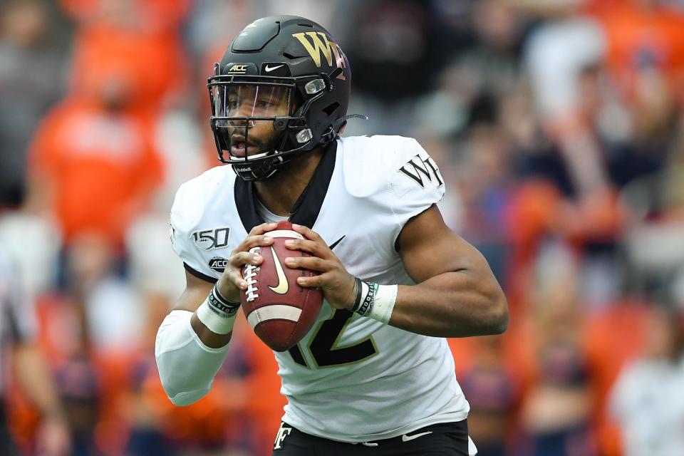 Wake Forest Demon Deacons quarterback Jamie Newman (12) runs with the ball against the Syracuse Orange during the first quarter at the Carrier Dome.