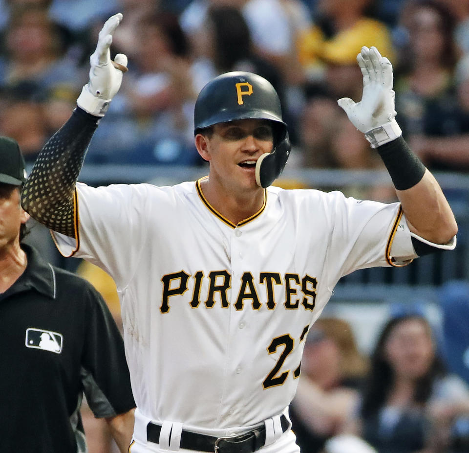 Pittsburgh Pirates' Kevin Newman celebrates as he stands on first base after driving in two runs with a single off Milwaukee Brewers relief pitcher Freddy Peralta during the third inning of a baseball game in Pittsburgh, Friday, May 31, 2019. (AP Photo/Gene J. Puskar)