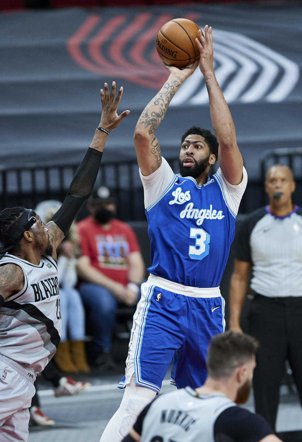 Los Angeles Lakers forward Anthony Davis, right, shoots over Portland Trail Blazers forward Robert Covington during the first half of an NBA basketball game in Portland, Ore., Friday, May 7, 2021. (AP Photo/Craig Mitchelldyer)