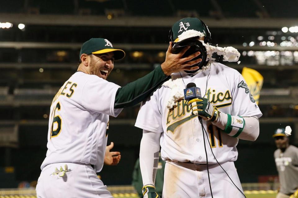Rajai Davis #11 of the Oakland Athletics is hit with a pie by teammate Adam Rosales #16 of the Oakland Athletics after Davis hit a two-run walk-off home run in the 9th inning against the Minnesota Twins at Oakland Alameda Coliseum (Lachlan Cunningham/Getty Images)