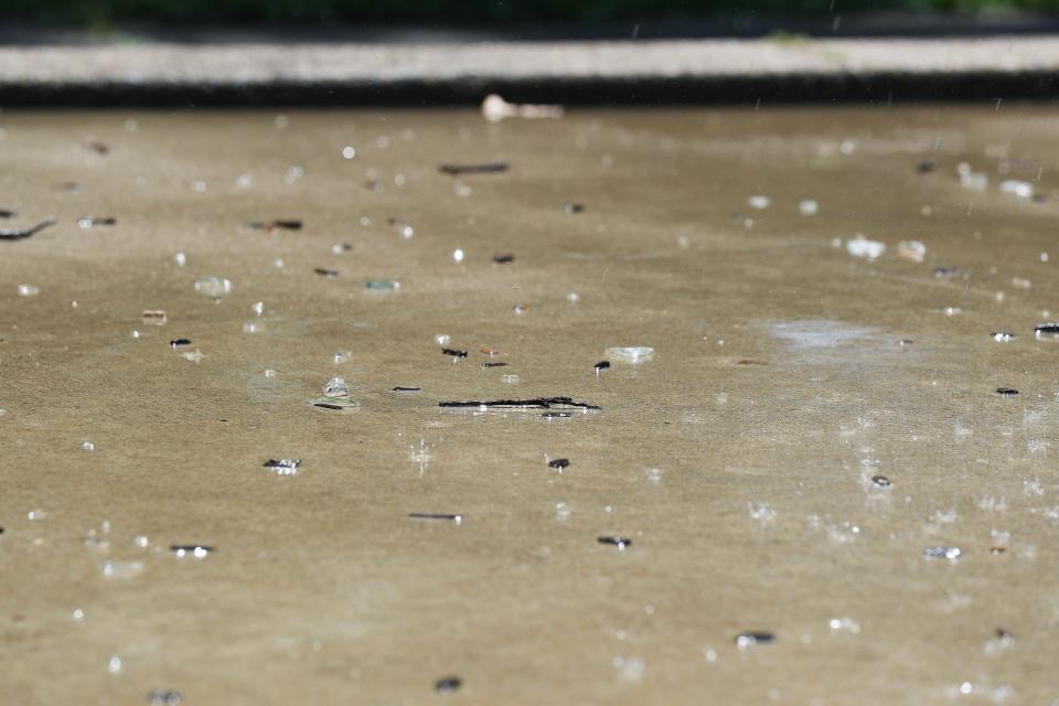 Shards of broken glass are peppered around the outdoor water fountain that was recently made operational inside the Leland Taylor Park in Louisville, Ky. on July 12, 2023.