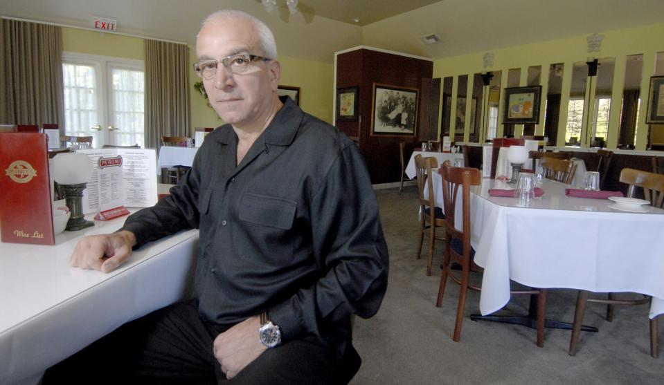 Mino Spada, owner of Mino's Cucina Italiana in Wausau, sits in the restaurant's dining area on July 5, 2007. The restaurant served pasta of all kinds, steak, pizza and seafood.