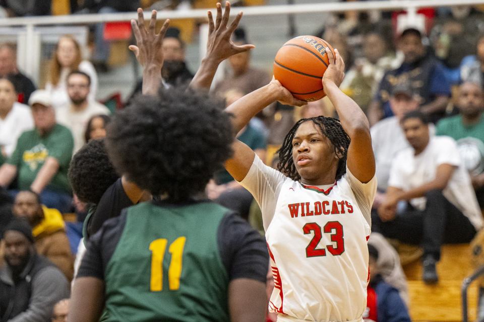Lawrence North High School junior Azavier Robinson (23) makes a pass during the first half of an IHSAA basketball game against Indianapolis Crispus Attucks High School, Tuesday, Dec. 19, 2023, at Lawrence North High School.