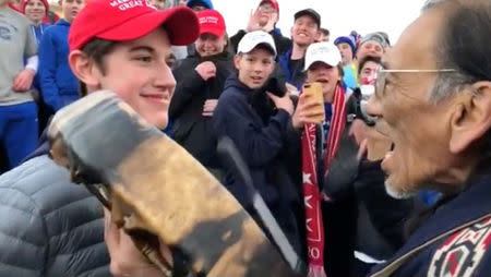 FILE PHOTO: A student from Covington Catholic High School stands in front of Native American Vietnam veteran Nathan Phillips in Washington, U.S., in this still image from a January 18, 2019 video by Kaya Taitano. Kaya Taitano/Social Media/via REUTERS