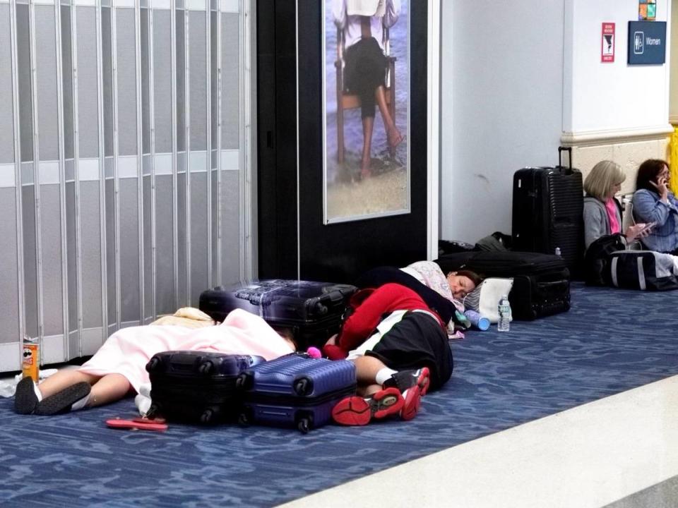 Travelers wait in Terminal 2 at the Fort Lauderdale-Hollywood International Airport for flights to be resumed on Thursday, April 13, 2023, after relentless rain and windy conditions prompted the airport to suspend arriving and departing flights on Wednesday.