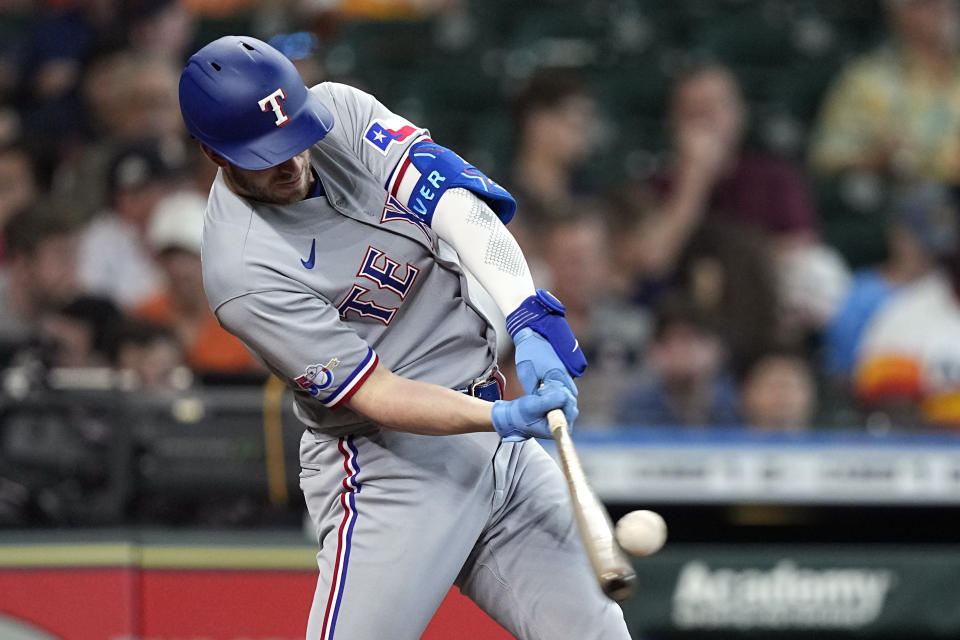 Texas Rangers' Mitch Garver hits a home run against the Houston Astros during the fifth inning of a baseball game Sunday, May 22, 2022, in Houston. (AP Photo/David J. Phillip)