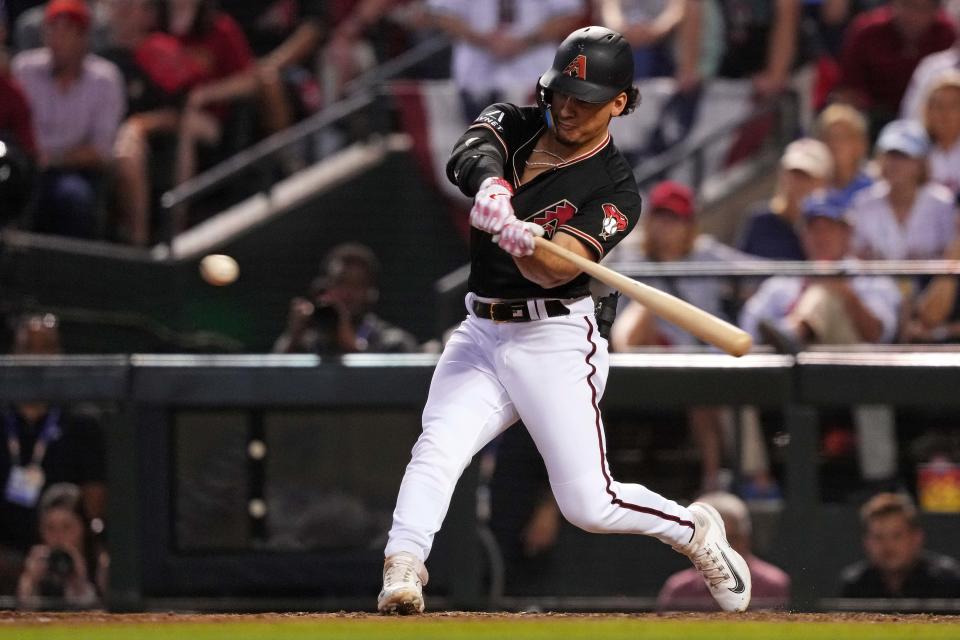 Arizona Diamondbacks center fielder Alek Thomas (5) hits a two-run home run during the eighth inning against the Philadelphia Phillies in game four of the NLCS for the 2023 MLB playoffs at Chase Field in Phoenix on Oct. 20, 2023.