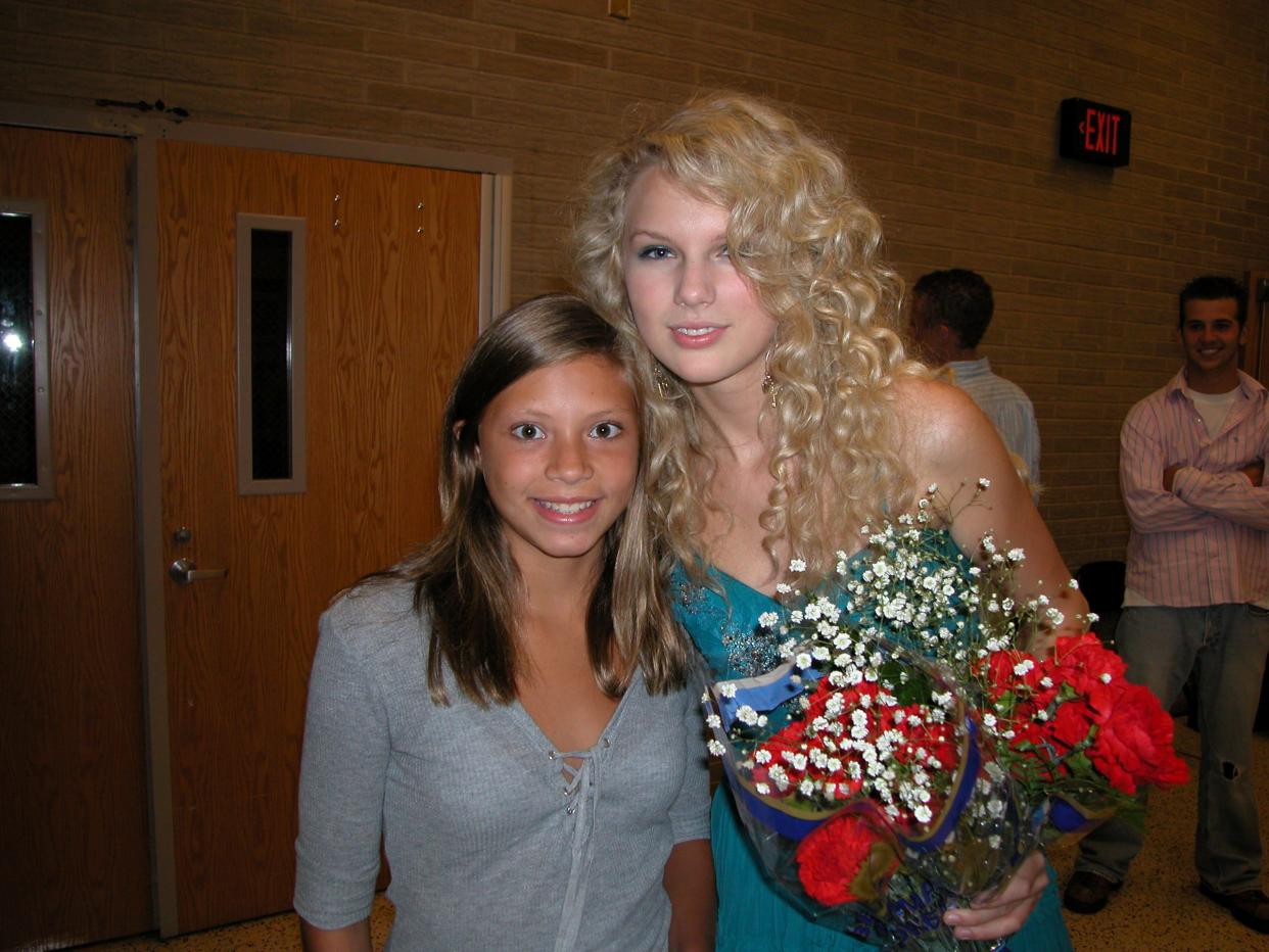 Taylor Swift poses with a young girl who attended her concert on Aug. 15, 2006, at Alliance High School. Swift was one of the opening acts for a fundraiser show for the Greater Alliance Carnation Festival. She's now Time magazine's 2023 Person of the Year.