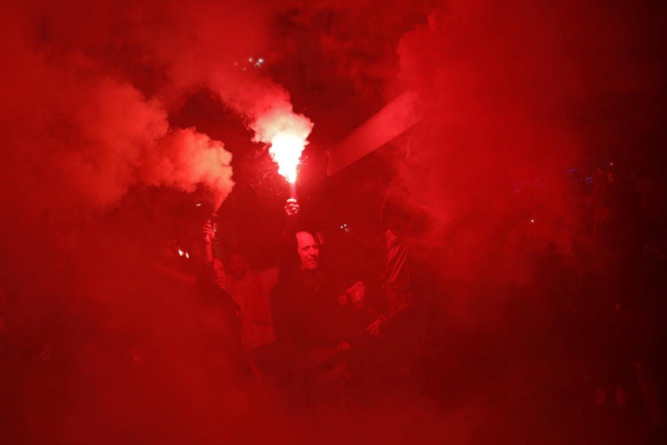 Pro-Spanish unity supporters light flares during a demonstration in Barcelona, Spain, Thursday, Oct. 17, 2019. Catalonia's separatist leader vowed Thursday to hold a new vote to secede from Spain in less than two years as the embattled northeastern region grapples with a wave of violence that has tarnished a movement proud of its peaceful activism. (AP Photo/Bernat Armangue)