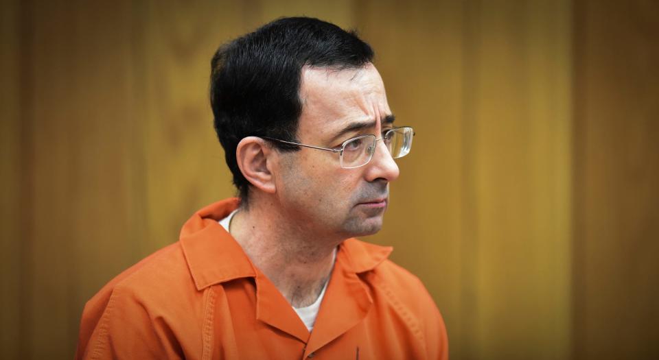 FILE - In this Feb. 5, 2018 file photo, Larry Nassar, former sports doctor who admitted molesting some of the nation's top gymnasts, appears in Eaton County Court in Charlotte, Mich. Thirteen sexual assault victims of Nassar are seeking $10 million each from the FBI, claiming a bungled investigation by agents led to more abuse by the sports doctor, lawyers said Thursday, April 21, 2022. (Matthew Dae Smith/Lansing State Journal via AP, File) ORG XMIT: MILAN502