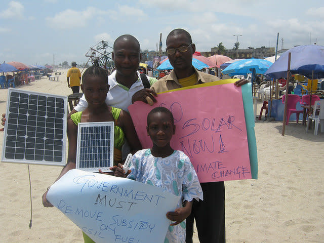 Challenging both young and old to take action to end fossil fuel in Nigeria. People gather on the beach for the Moving the Planet work party in Lagos Nigeria