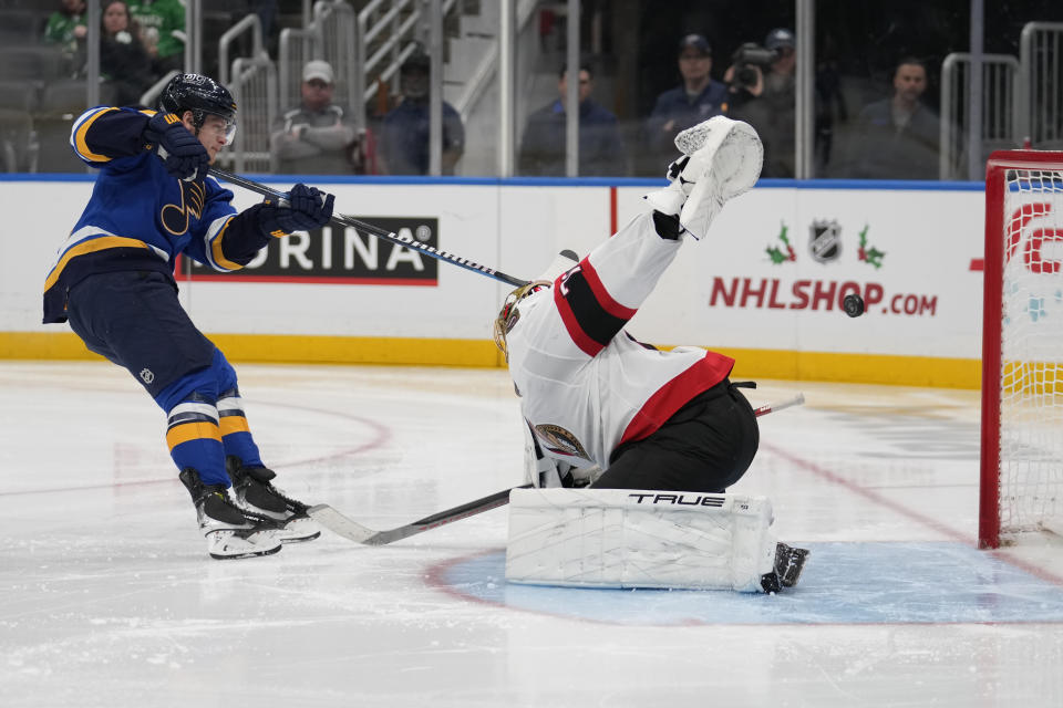 St. Louis Blues' Torey Krug, left, is unable to score past Ottawa Senators goaltender Joonas Korpisalo during the second period of an NHL hockey game Thursday, Dec. 14, 2023, in St. Louis. (AP Photo/Jeff Roberson)