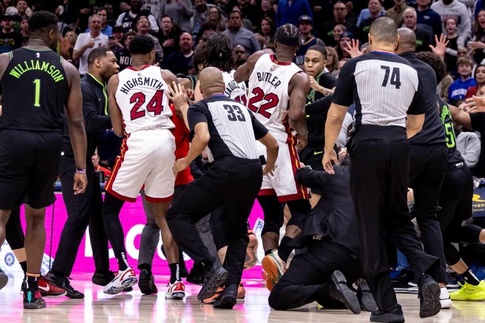 Miami Heat forward Jimmy Butler (22) and New Orleans Pelicans forward Naji Marshall (8) and guard Jose Alvarado (15) are ejected after a melee due to a play during the second half at Smoothie King Center.