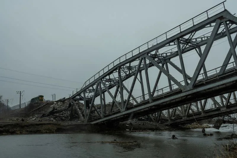 FILE PHOTO: A view shows a railway bridge over the Irpin river destroyed by heavy shelling in Irpin