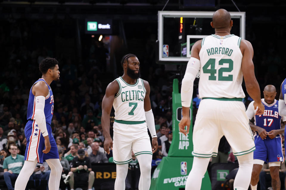 Wearing his shorts backwards, Boston Celtics guard Jaylen Brown (7) looks on during a break in the action as Philadelphia 76ers forward P.J. Tucker (17) adjusts his drawstring during the first half of a preseason NBA basketball game, Sunday, Oct. 8, 2023, in Boston. (AP Photo/Mary Schwalm)