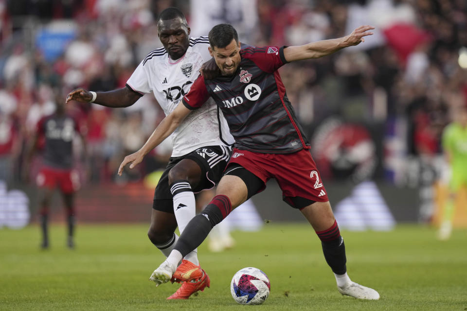 Toronto FC defender Matt Hedges, right,battles for the ball with D.C. United forward Christian Benteke during first-half MLS soccer match action in Toronto, Ontario, Saturday, May 27, 2023. (Chris Young/The Canadian Press via AP)