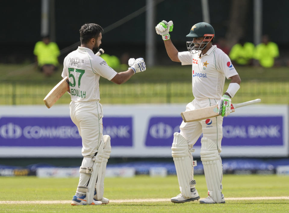 Pakistan's captain Babar Azam, right, congratulates Abdullah Shafique for scoring a century during the third day of the second cricket test match between Sri Lanka and Pakistan in Colombo, Sri Lanka on Wednesday, Jul. 26. (AP Photo/Eranga Jayawardena)