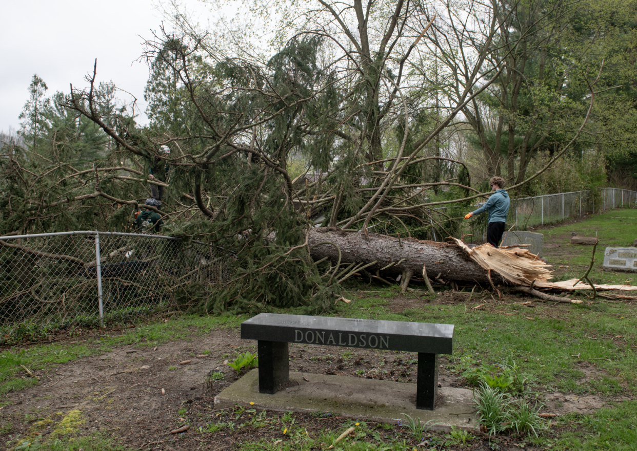 Matthew Kolaczek, 16, a Windham sophomore, left school early Friday, April 19, 2024, to help clean up debris from a fallen tree at Windham Cemetery, two days after an EF-1 tornado struck in town.