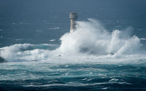 Waves break on Longships lighthouse off the coast of Lands End, Cornwall, - Credit: Ben Birchall/PA