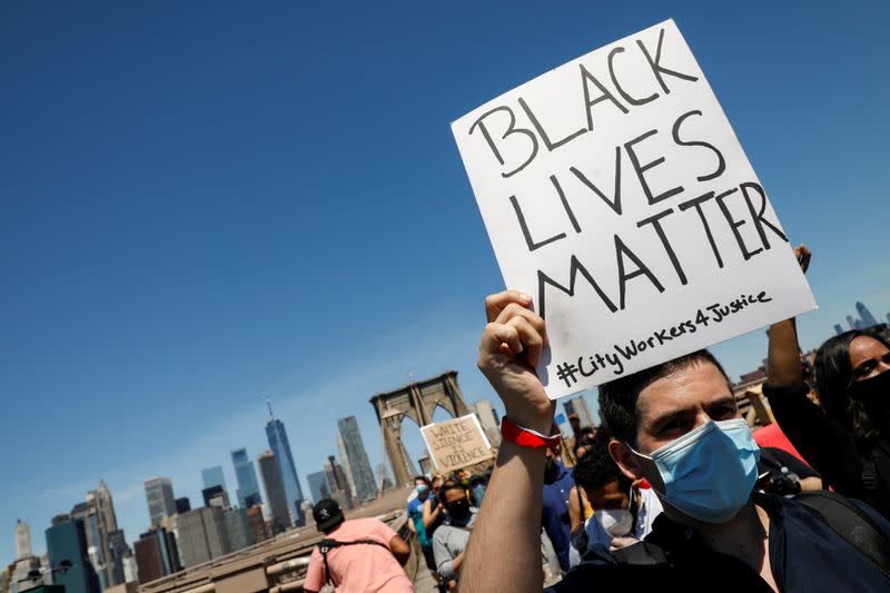 Current and former New York City Mayor's staff march across the Brooklyn Bridge to call for reforms during a protest against racial inequality in the aftermath of the death in Minneapolis police custody of George Floyd, in New York