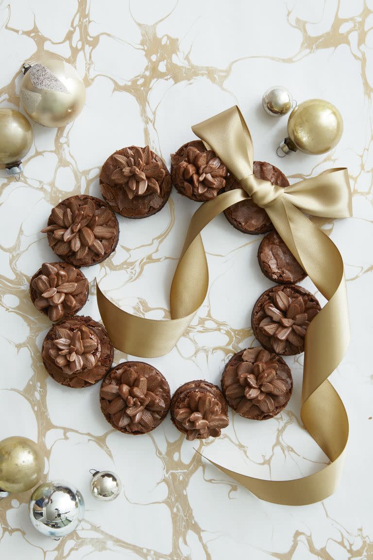 <p>Arrange any type of cookie (or baked good!) into a wreath and add an assortment of bows and ornaments for an instant dose of holiday cheer. </p><p>Get the <a href="https://www.countryliving.com/food-drinks/recipes/a40522/pinecone-brownie-wreath-recipe/" rel="nofollow noopener" target="_blank" data-ylk="slk:Pinecone Brownie Wreath recipe;elm:context_link;itc:0;sec:content-canvas" class="link "><strong>Pinecone Brownie Wreath recipe</strong></a> from Country Living.</p>