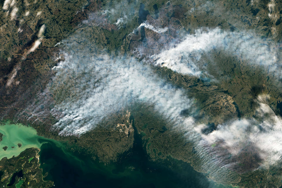 A view shows smoke rising due to wildfire in Yellowknife, Northwest Territories, Canada, August 16, 2023.   NASA EARTH OBSERVATORY/Handout via REUTERS    THIS IMAGE HAS BEEN SUPPLIED BY A THIRD PARTY. MANDATORY CREDIT REFILE - CORRECTING LOCATION FROM BRITISH COLUMBIA TO NORTHWEST TERRITORIES