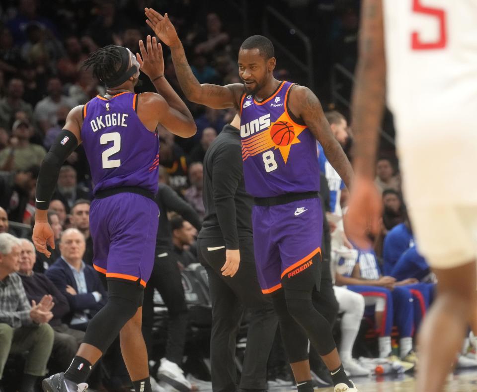 Feb 16, 2023; Phoenix, Arizona, USA; Phoenix Suns guard Terrence Ross (8) high-fives teammate 	Josh Okogie (2) during their game against the Los Angeles Clippers at Footprint Center. 