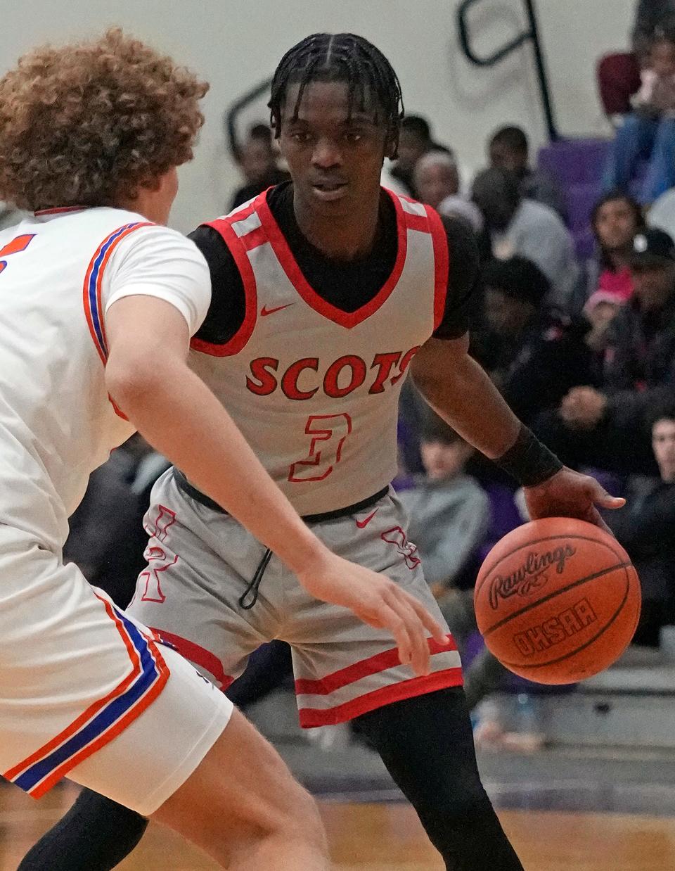 Walnut Ridge senior point guard Dominique Aekins looks to make a move around Olentangy Orange's Devin Brown on Jan. 20.