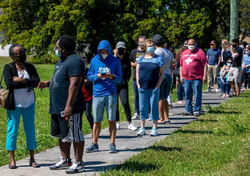 People wait in line to get vaccinated at the FEMA Florida City vaccination site at the Florida City Youth Center on Sunday, March 7, 2021.