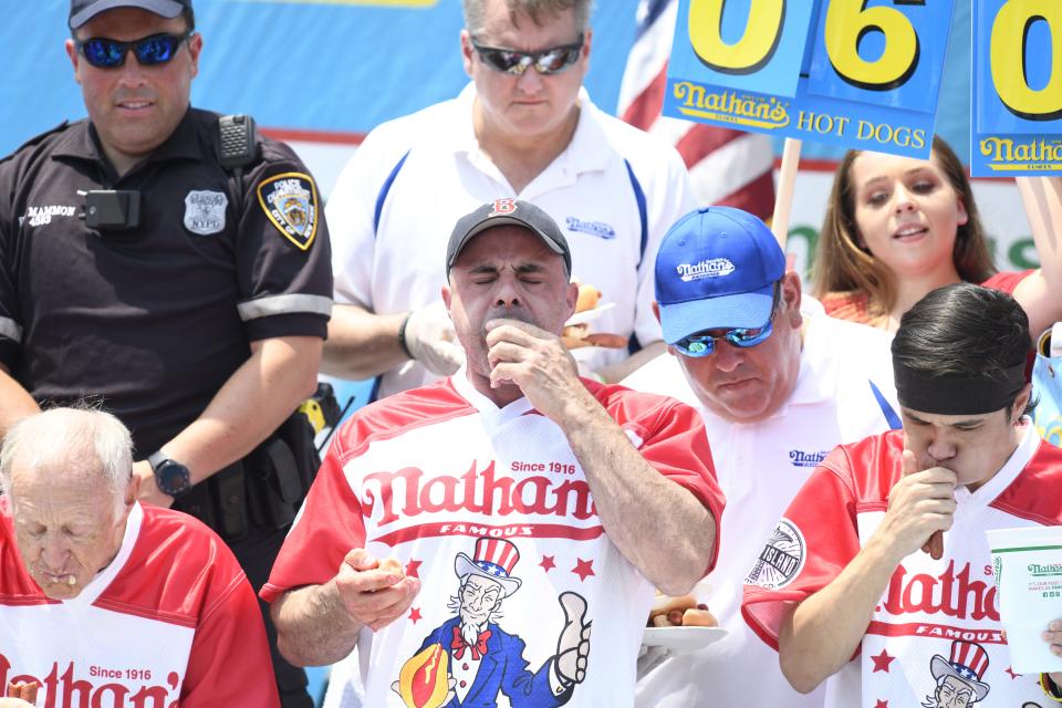 Geoffrey Esper consumes hot dogs during the Nathan’s Hot Dog Eating Contest, Wednesday, July 4, 2018, at Coney Island, New York. 