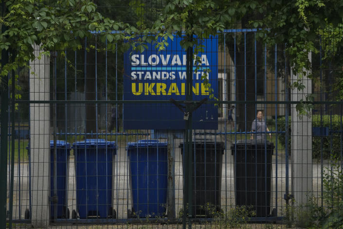 A billboard showing a support for Ukraine on display in between fences at the Slovakia Embassy in Beijing, Thursday, May 17, 2023. Embassies in Beijing have been asked by the Chinese government to avoid displaying propaganda after some raised Ukrainian flags or set up placards declaring support for Ukraine. (AP Photo/Andy Wong)