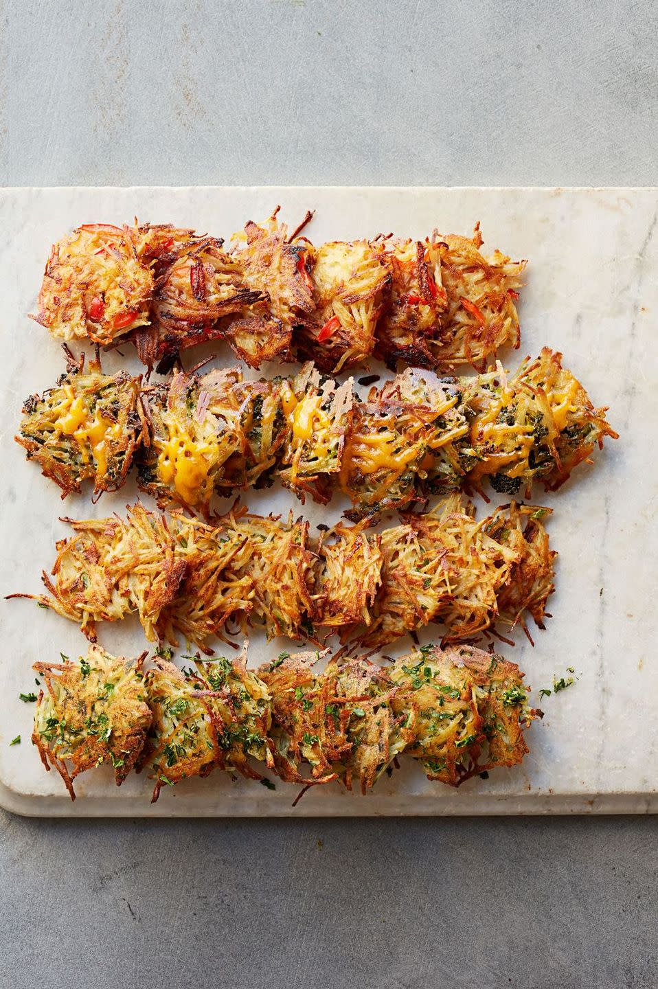 <p>These flavored hash browns are perfectly bite-sized — which makes them ideal for snacking on in bed. </p><p><strong>Get the recipe for:</strong></p><p><em>• <a href="https://www.goodhousekeeping.com/food-recipes/a15998/smoky-red-pepper-hash-browns-recipe-ghk0514/" rel="nofollow noopener" target="_blank" data-ylk="slk:Smoky Red Pepper Hash Browns »;elm:context_link;itc:0;sec:content-canvas" class="link ">Smoky Red Pepper Hash Browns »</a></em></p><p><em>• <a href="https://www.goodhousekeeping.com/food-recipes/a16039/garlicky-broccoli-cheddar-hash-browns-recipe-ghk0514/" rel="nofollow noopener" target="_blank" data-ylk="slk:Garlicky Broccoli Cheddar Hash Browns »;elm:context_link;itc:0;sec:content-canvas" class="link ">Garlicky Broccoli Cheddar Hash Browns »</a></em></p><p><em>• <a href="https://www.goodhousekeeping.com/food-recipes/a16009/spicy-southern-hash-browns-recipe-ghk0514/" rel="nofollow noopener" target="_blank" data-ylk="slk:Spicy Southern Hash Browns »;elm:context_link;itc:0;sec:content-canvas" class="link ">Spicy Southern Hash Browns »</a></em></p><p><em>• </em><a href="https://www.goodhousekeeping.com/food-recipes/a15888/zesty-herb-hash-browns-recipe-ghk0514/" rel="nofollow noopener" target="_blank" data-ylk="slk:Zesty Herb Hash Browns »;elm:context_link;itc:0;sec:content-canvas" class="link "><em>Zesty Herb Hash Browns »</em></a></p>