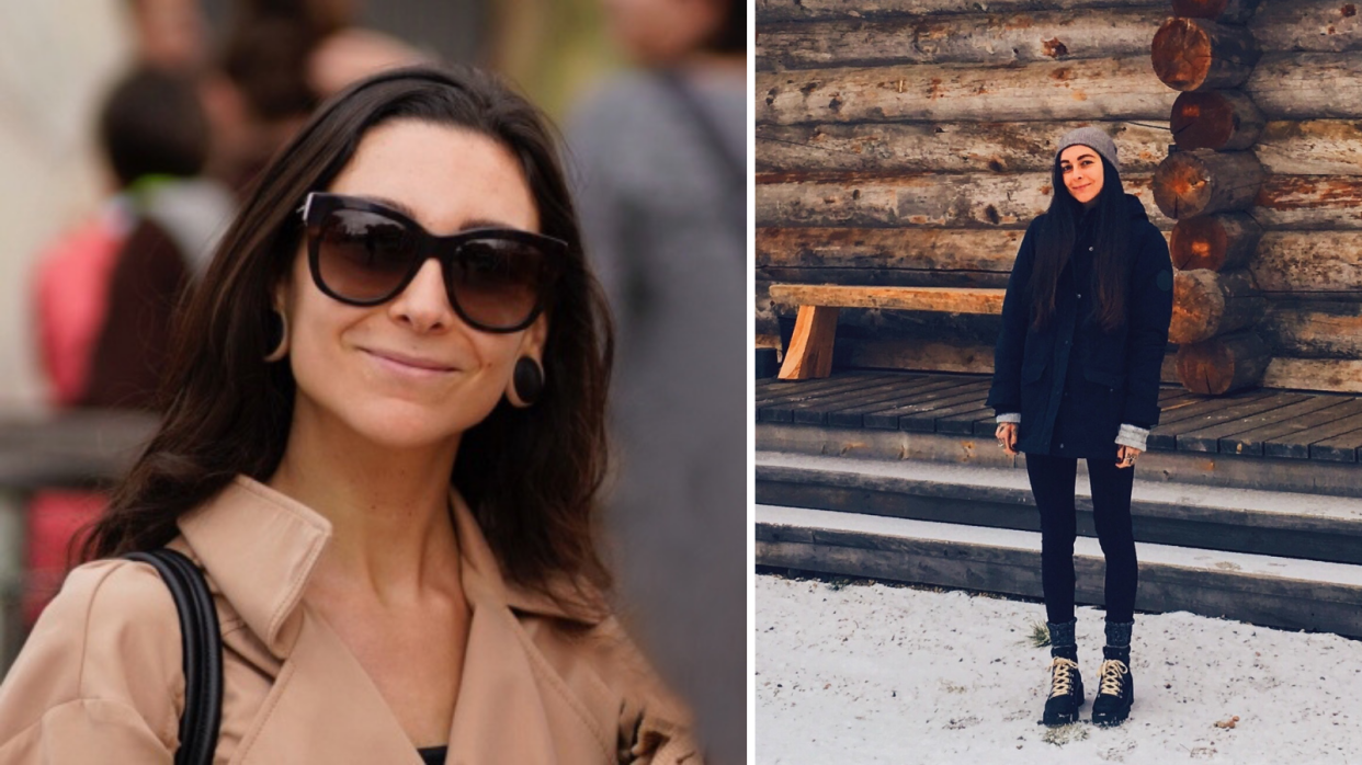 Pictured: Sara Ocean smiling while wearing glasses, stnading in front of wooden wall. 