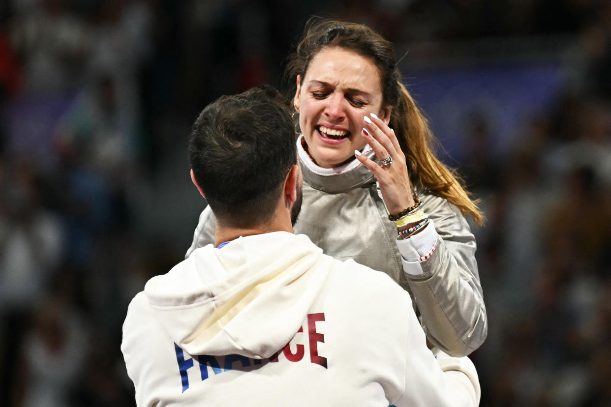 France's Manon Apithy-Brunet (R) celebrates after winning against South Korea's Choi Se-bin in the women's sabre individual semi-final bout during the Paris 2024 Olympic Games at the Grand Palais in Paris, on July 29, 2024. (Photo by Fabrice COFFRINI / AFP)