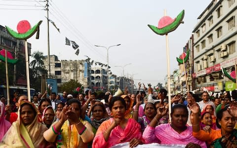 Supporters of Bangladesh Awami League march along a street as they take part in a rally ahead of December 30 general election vote - Credit:  MUNIR UZ ZAMAN/AFP