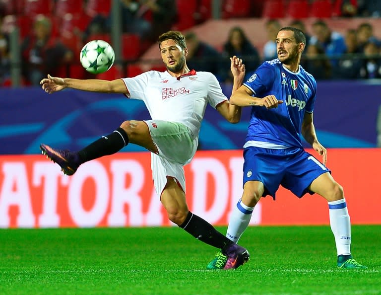 Sevilla's forward Franco Vazquez (L) clashes with Juventus' defender Leonardo Bonucci on November 22, 2016