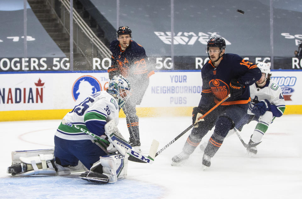 Edmonton Oilers' Josh Archibald (15) is stopped by Vancouver Canucks goalie Thatcher Demko (35) during the second period of an NHL hockey game Saturday, May 8, 2021, in Edmonton, Alberta. (Jason Franson/The Canadian Press via AP)