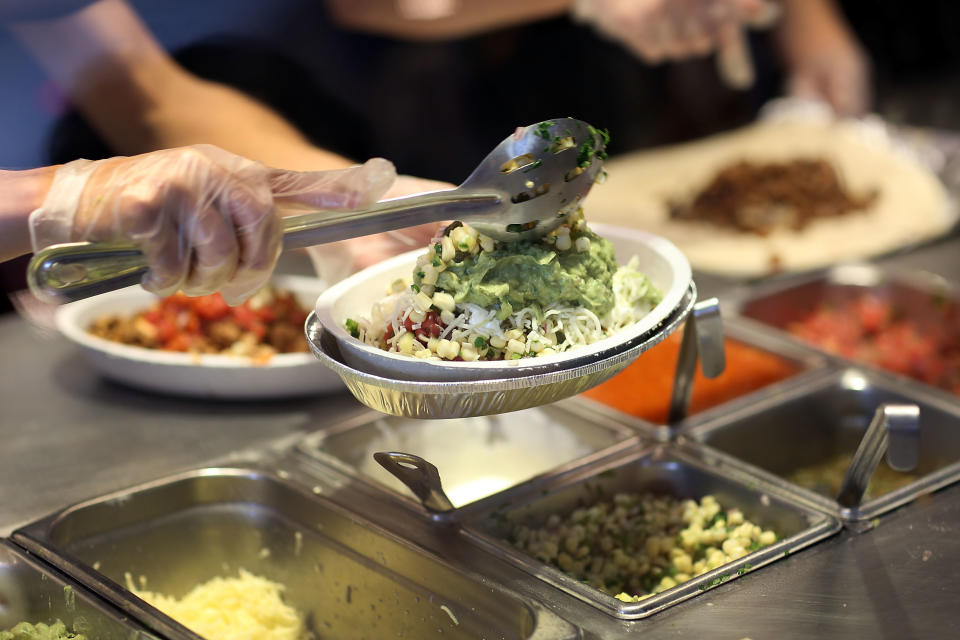 MIAMI, FL - APRIL 27:  Chipotle restaurant workers fill orders for customers on the day that the company announced it will only use non-GMO ingredients in its food on April 27, 2015 in Miami, Florida.  The company announced, that the Denver-based chain would not use the GMO's, which is an organism whose genome has been altered via genetic engineering in the food served at Chipotle Mexican Grills.  (Photo by Joe Raedle/Getty Images)