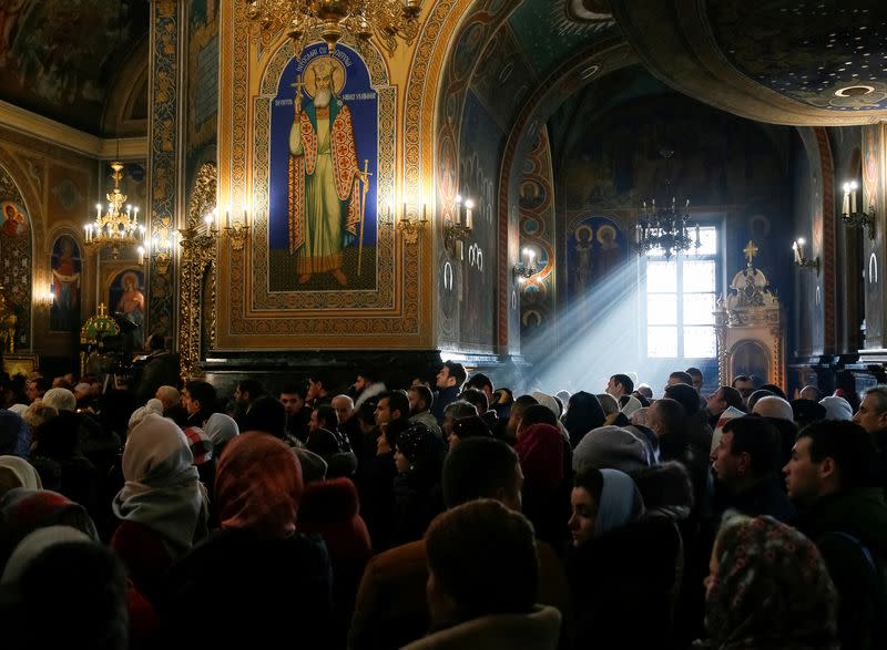 FILE PHOTO: People attend a service for Orthodox Epiphany celebrations in Chisinau