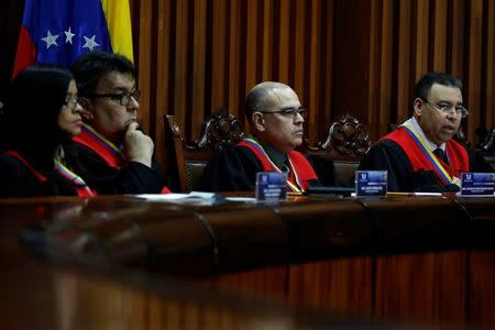 Venezuela's Supreme Court Second Vice President and President of the Constitutional Chamber Juan Mendoza (R) sits with other members of the Constitutional Chamber as he gives a news conference in Caracas, Venezuela, July 21, 2017. REUTERS/Carlos Garcia Rawlins