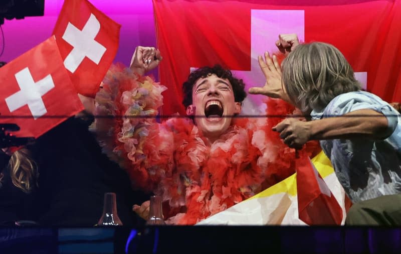 Nemo (C) from Switzerland reacts during the scoring at the final of the Eurovision Song Contest (ESC) 2024 in the Malmo Arena. Jens Büttner/dpa