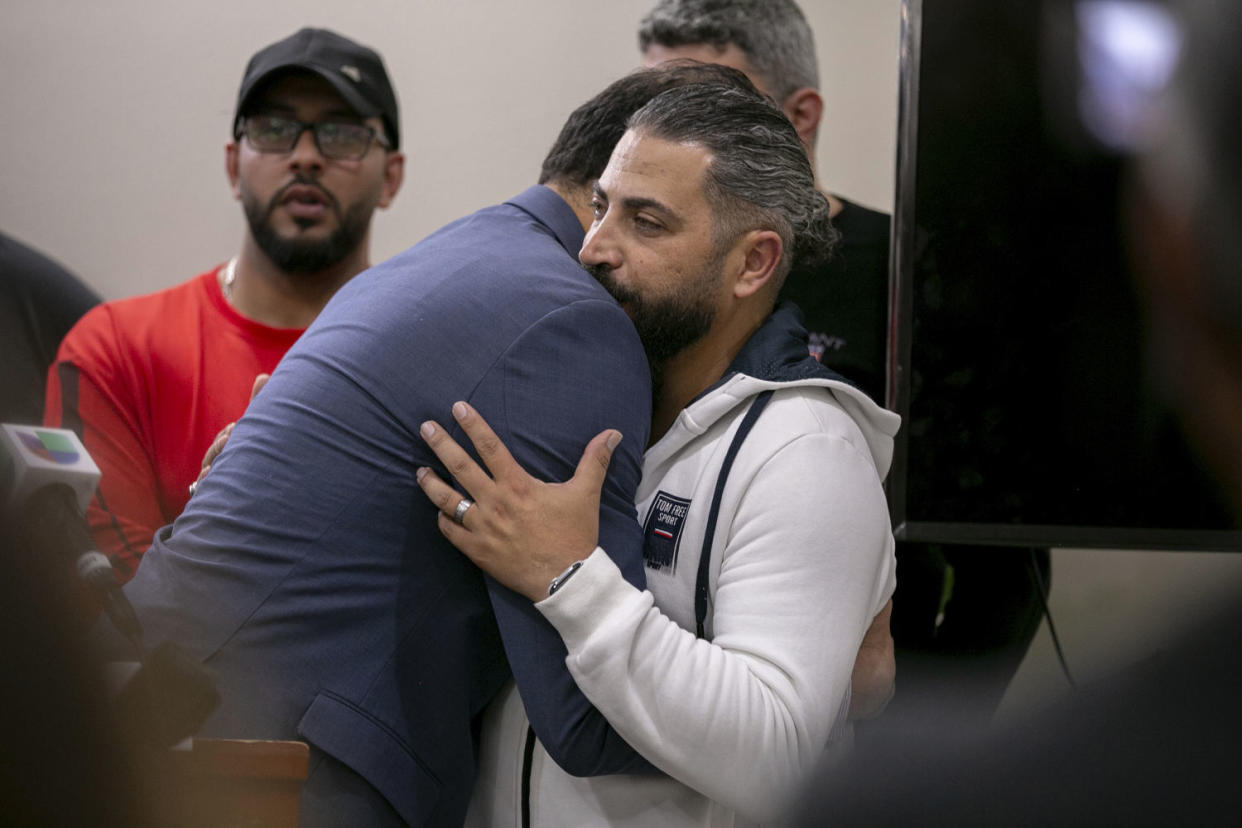 State Rep. Abdelnasser Rashid, D-21st District, embraces Oday Al-Fayoume, father of Wadea Al-Fayoume, 6, during a news conference at the Muslim Community Centre on Chicago's Northwest Side